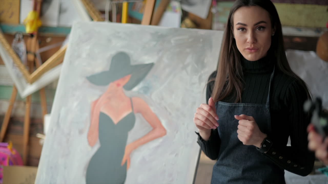 Woman presenting a painting at an art gallery workshop