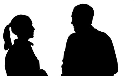 silueta dos profesionales médicos discuten con un paciente