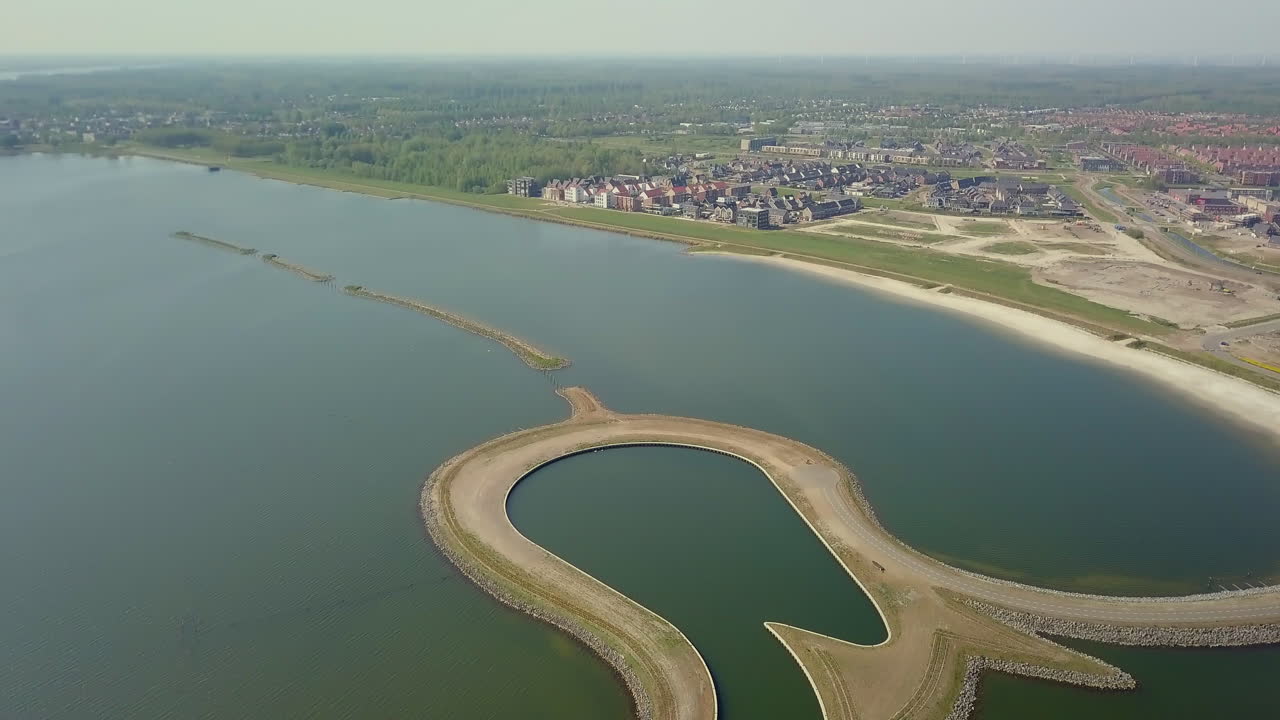 Aerial drone shot of tilting down over the manmade Tulip Island located at the coastline of the Zeewolde, Flevoland, the Netherlands.