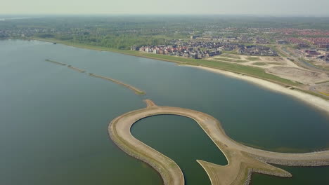 aerial drone shot of tilting down over the manmade tulip island located at the coastline of the zeewolde, flevoland, the netherlands.