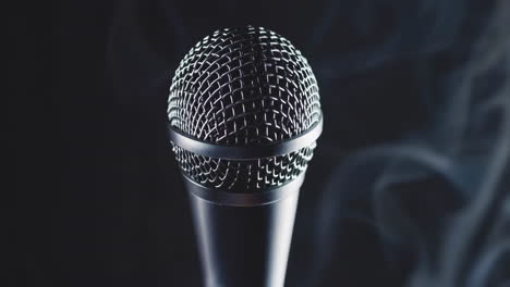 close-up of a microphone with smoke on a dark background