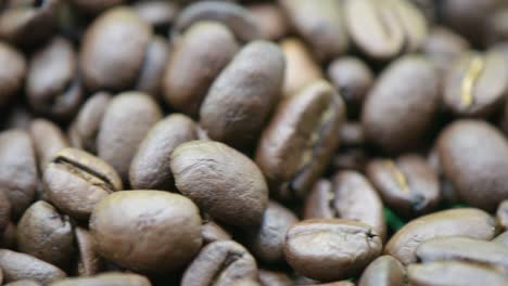 slow panning on a bunch of coffee beans, extreme close-up