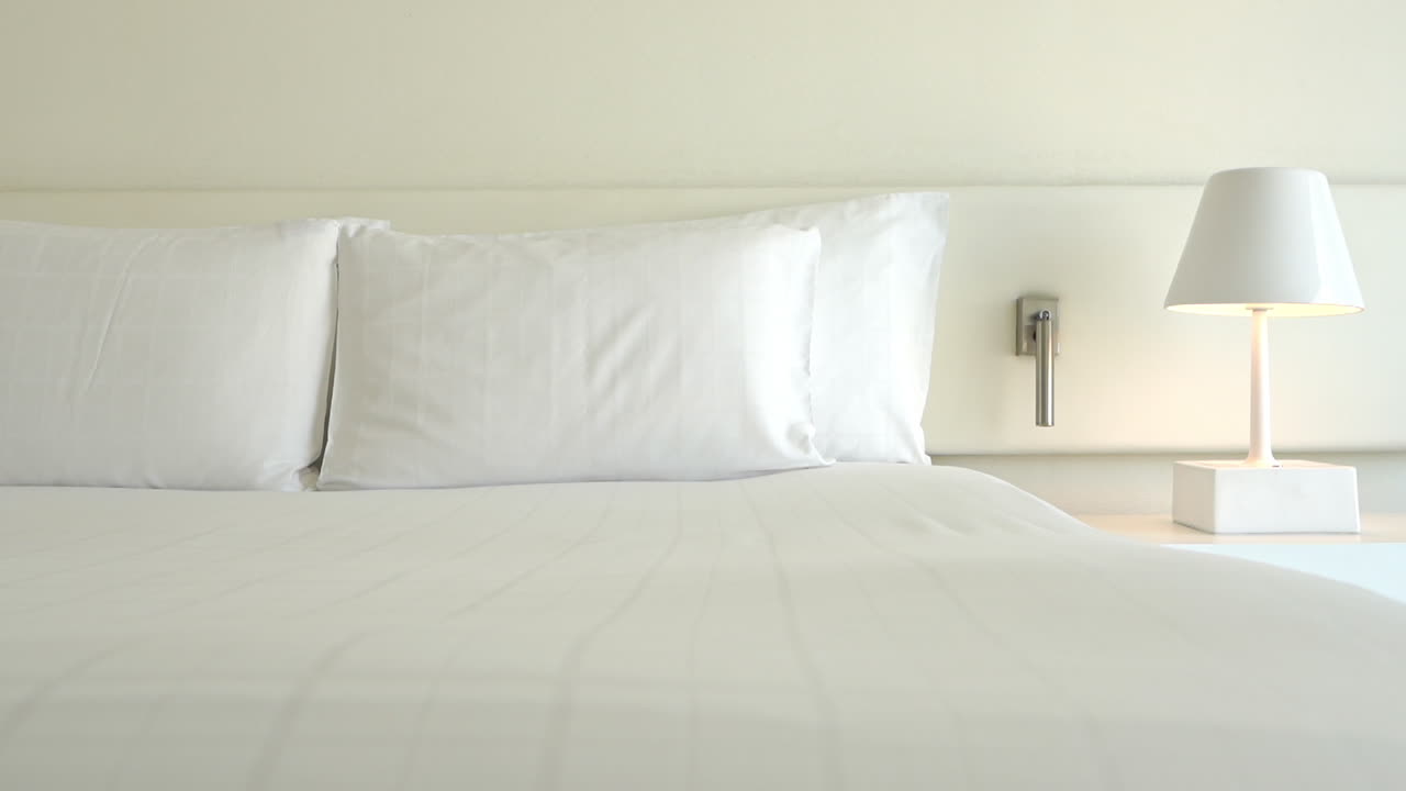 Pan across an empty resort room and bed