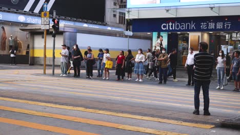 pedestrians and vehicles at a bustling intersection