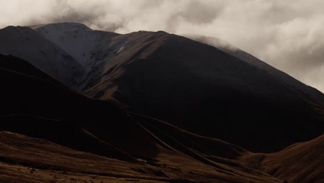new zealand autumn season landscape with mountains during rain, with cloud moving fast in the mountains