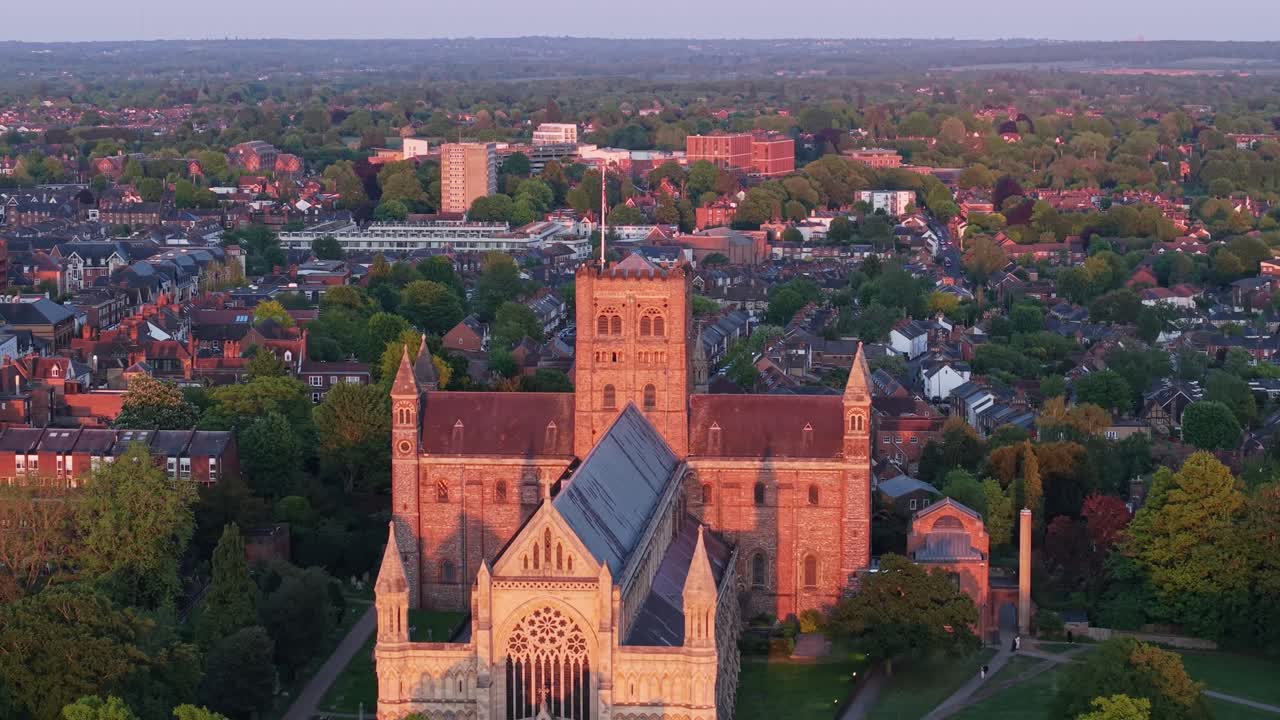 A cinematic drone pullback with tilt-down motion unveils St Albans Cathedral from its main entrance, revealing the majestic gothic temple in full glory