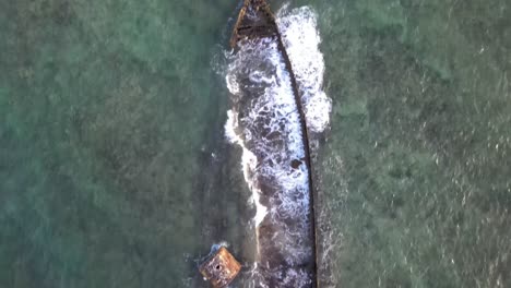 drone aerial directly overhead a shipwreck slowly flying forward