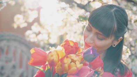 woman smelling spring flowers