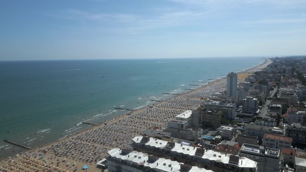 Aerial view of Jesolo beach near Venice in Italy. Adriatic Sea in the Mediterranean with beaches full of tourists on holiday and traveling in summer.