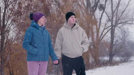 couple walking in snowy park