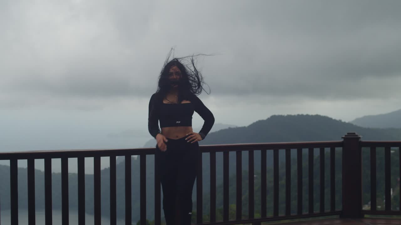 Captivated by the emerald hills and sapphire ocean, a young Latina takes in the vastness of La Vigie