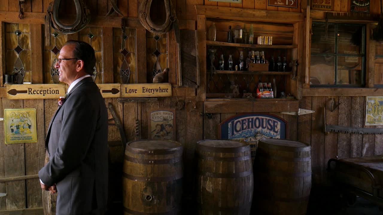 Atlanta, GA - November 21, 2018: A father gets a first look at his daughters beautiful white wedding dress on her special day at a rustic rural farm in the country.