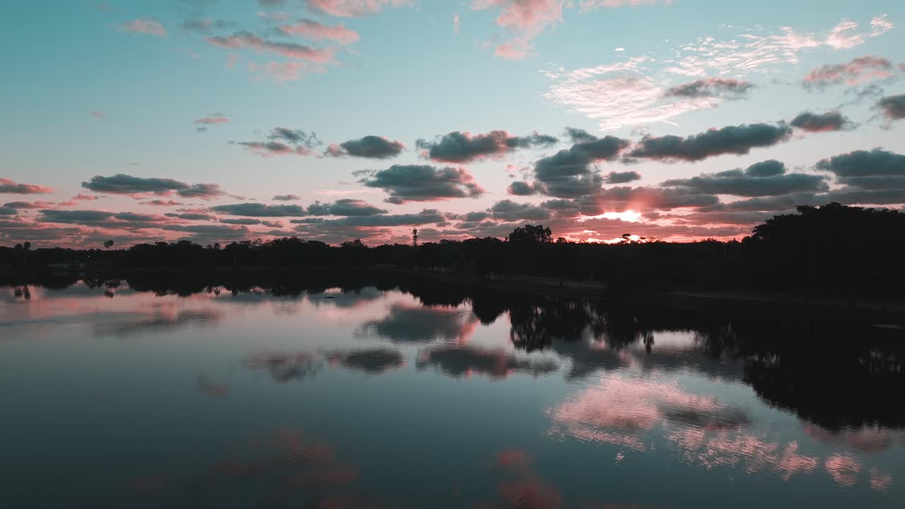 Smooth aerial footage over the residential lake in Winston Park, Florida, highlighting calm waters, suburban houses and community layout, captured in clear daylight with cinematic drone movement