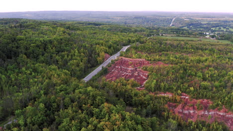 Aerial,-Drone-view-of-beautiful-forest-in-Canada-Badlands-landscape,-road,-trees,-gorgeous-wilderness