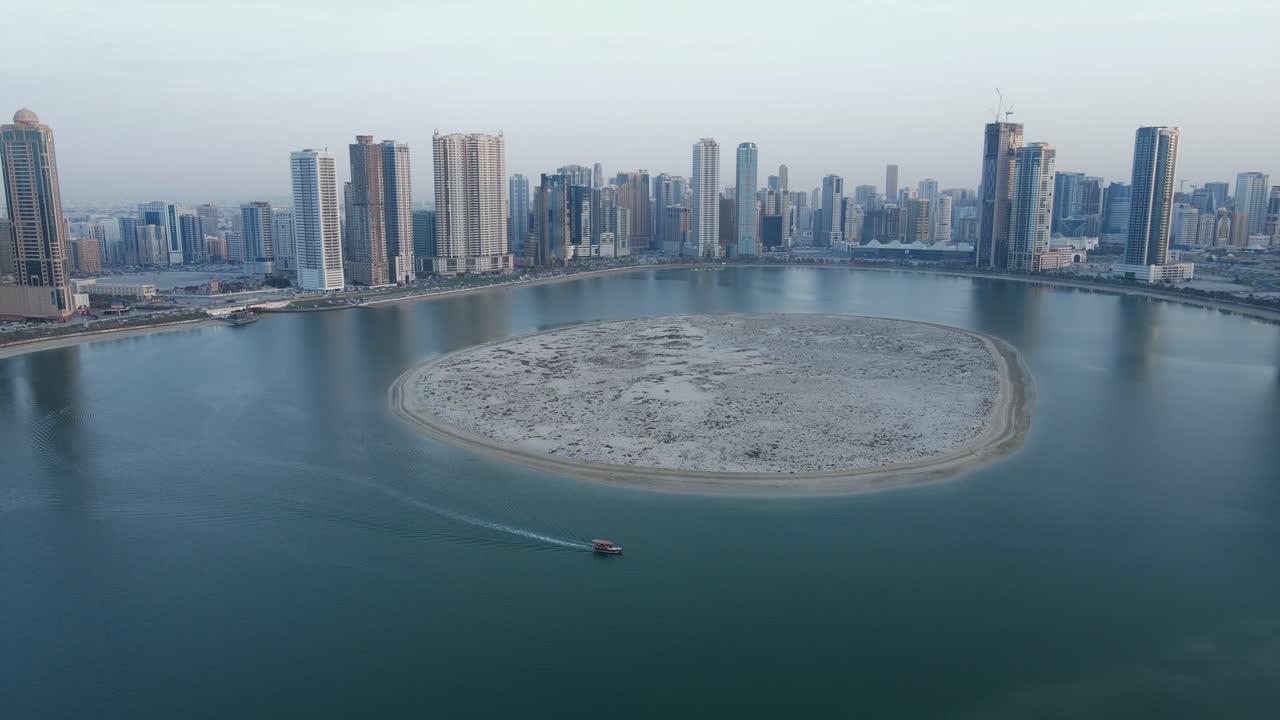 4K: Sharjah From the Top, Aerial view of Sharjah's Al Khan lake and Al Khan island with Moderns skyscrapers, Travel tourism business in the United Arab Emirates