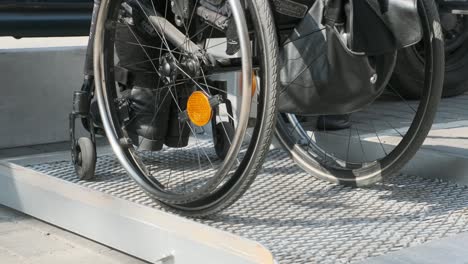 woman with disabilities loading a specialized car with a lift