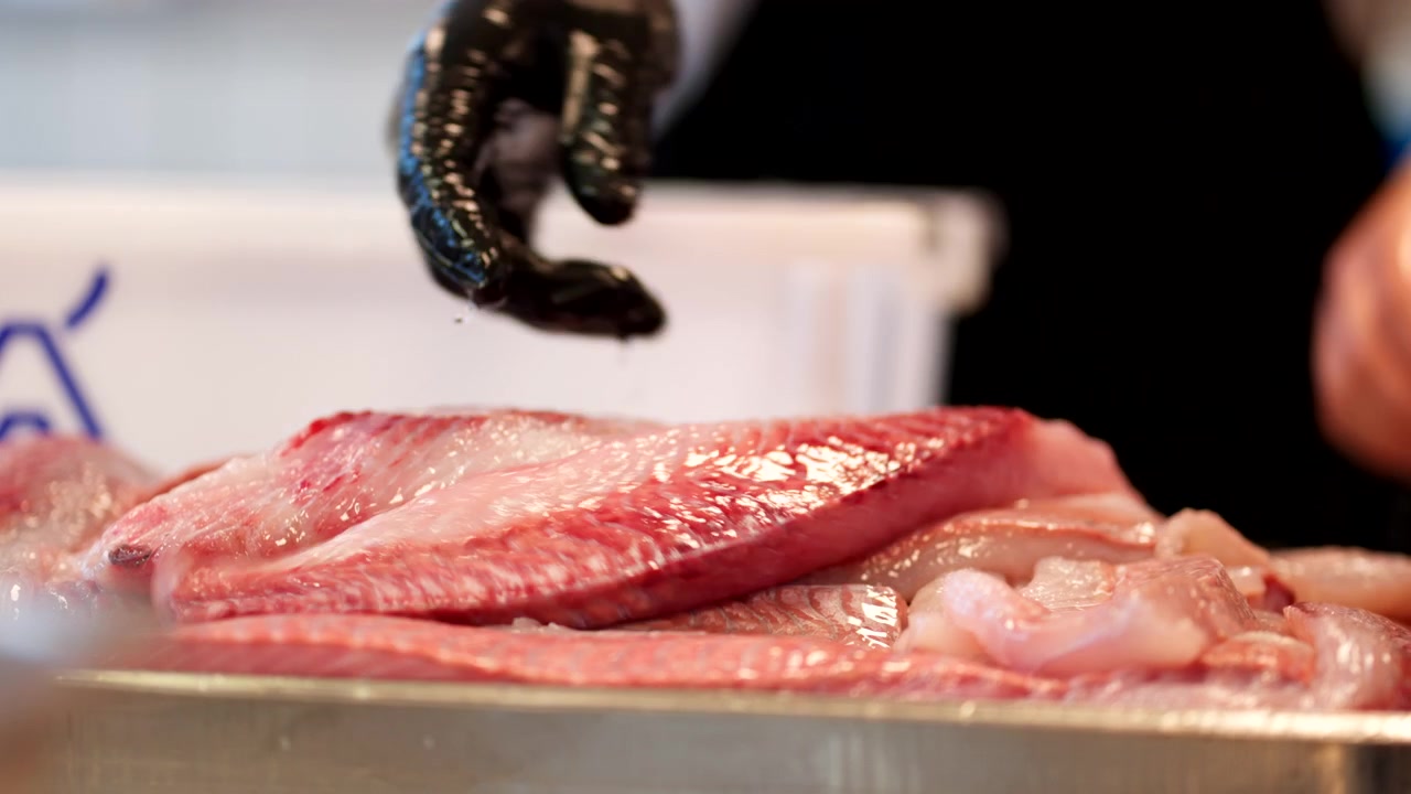 Person Washing Salted Herring Fish Meat In Fillet. - closeup shot