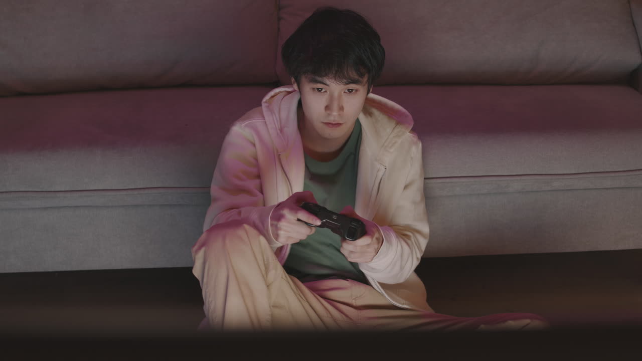 Young Asian Man Playing Video Game