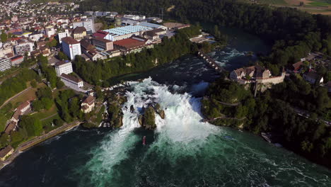 High-altitude-aerial-approach-of-the-roaring-waterfall-Rheinfall-at-Schaffhausen-in-Switzerland