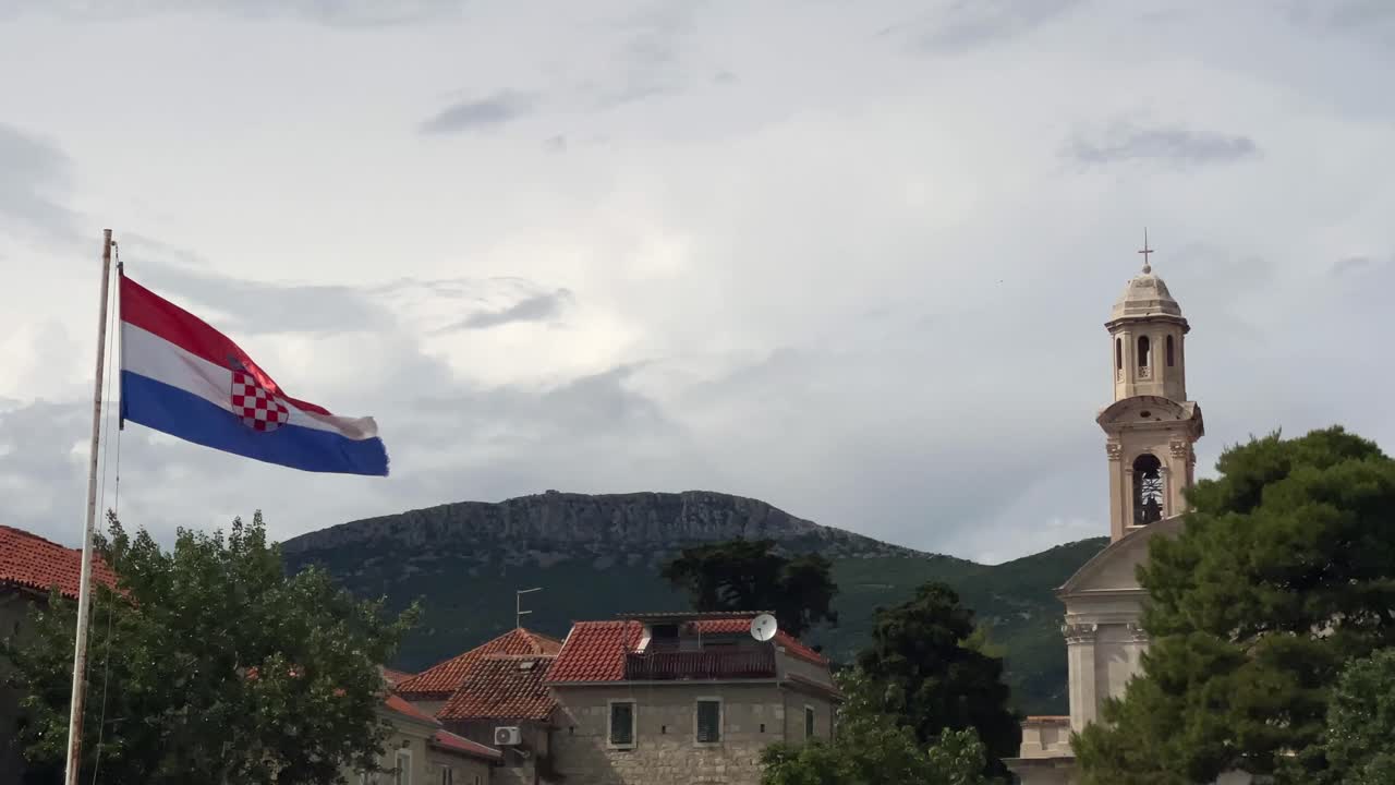 Croatian flag flying with Kaštel Lukšić in the background