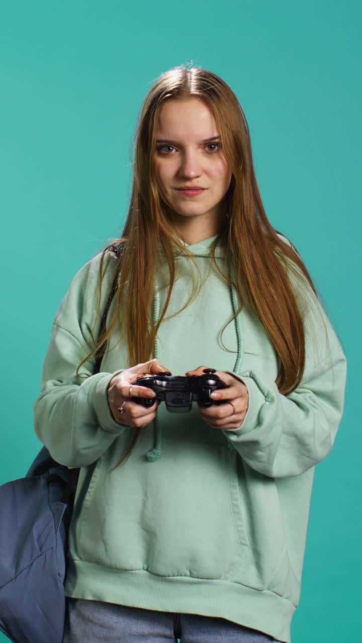 Vertical video Young gamer girl holding controller, focused on finishing game