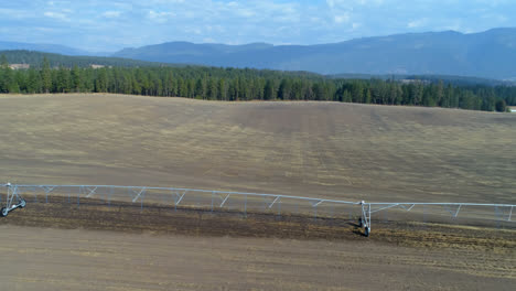 Aerial-view-of-irrigation-sprinkles-used-in-harvested-field-4k