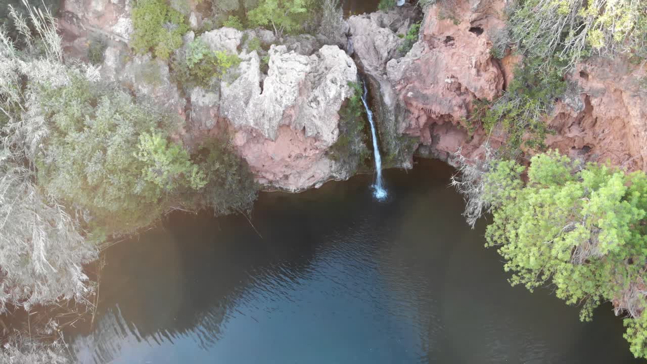 Waterfall of Pego do Inferno at dusk in Tavira, Algarve, Portugal - High angle Orbit Aerial