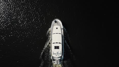 luxurious white yacht sailing on water, top view