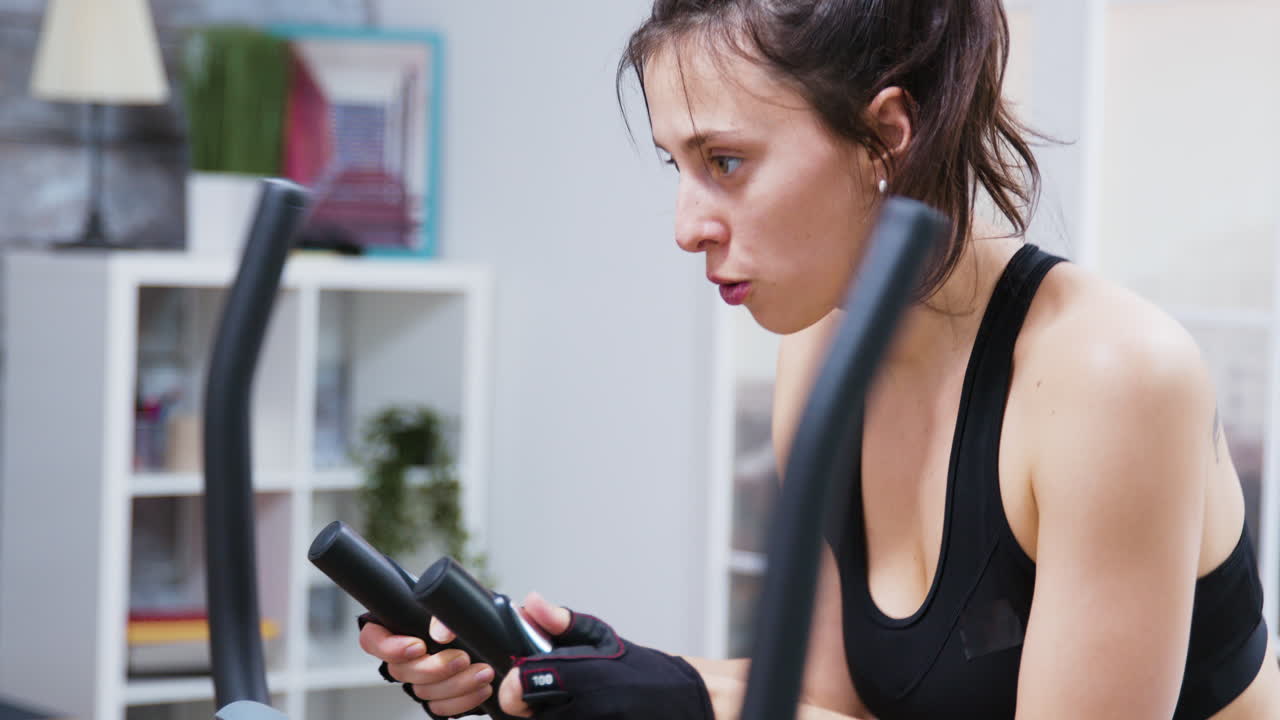 Woman Working Out on Exercise Bike at Home