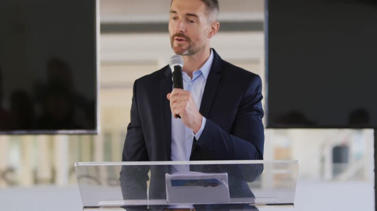 Male speaker addressing the audience at a business conference