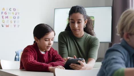 teacher and student using tablet in classroom