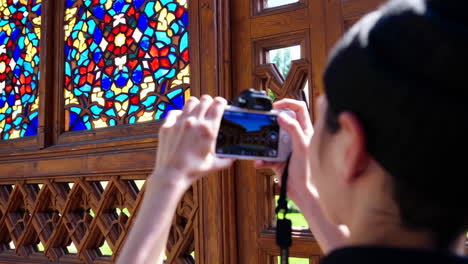 people taking photos at a palace in central asia