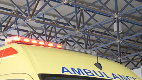 close-up of the top of a yellow ambulance with it's flashing lights