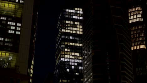 night view of illuminated office buildings in frankfurt, germany with lit windows