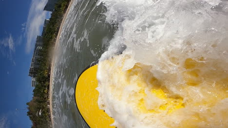 surfer paddle to catch wave while being washed away from surfboard, pov vertical