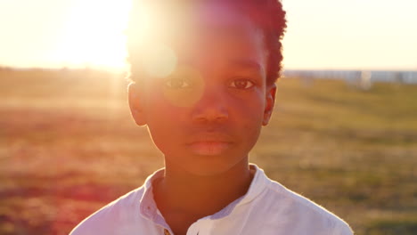 child, face and park with lens flare