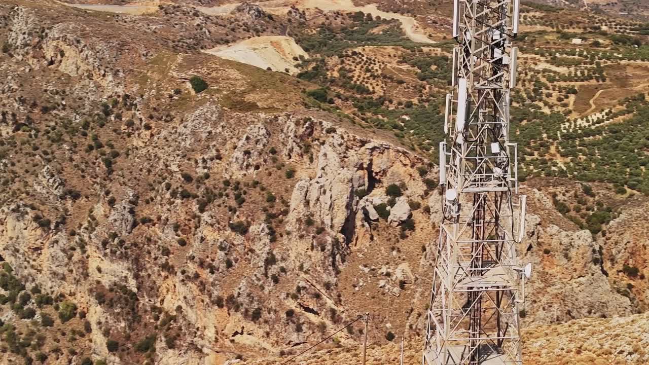 Vista aérea de una torre de telecomunicaciones en un paisaje montañoso y rocoso
