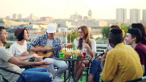 friends enjoying a rooftop party with music