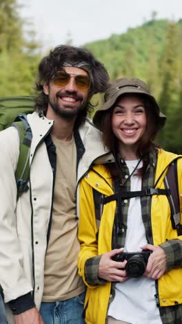 happy couple hiking in the woods