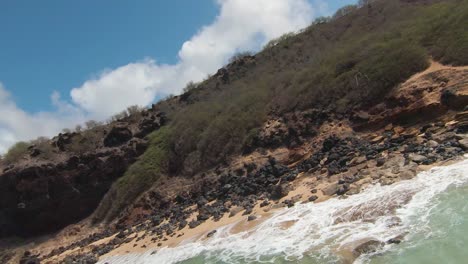 aerial reverse shot of incredible shore view from fpv race drone on paradise island of hawaii