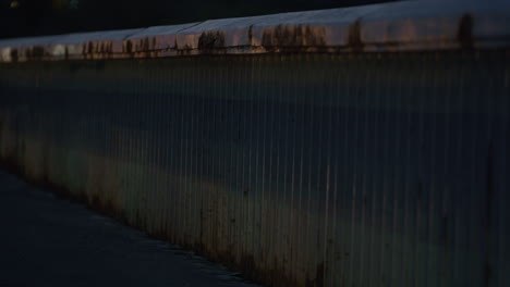 bridge handrail at night close up. city safety metal constructions concept.
