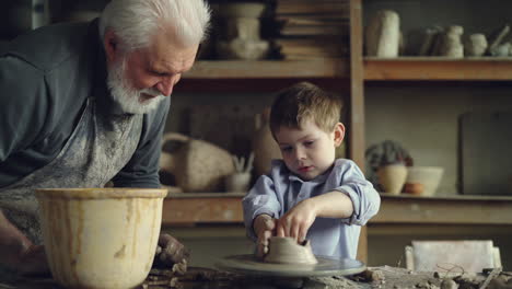grandfather and grandson making pottery