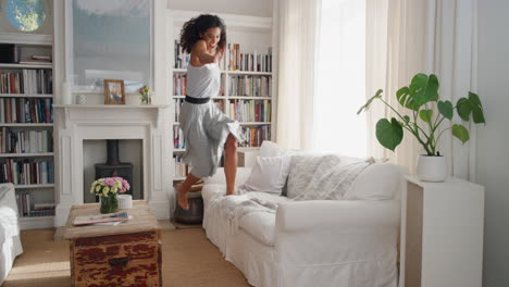 happy dancing woman celebrating achievement with victory dance having fun enjoying success wearing beautiful dress at home 4k