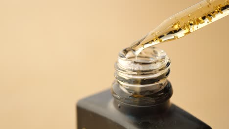 gold serum dropper bottle close-up