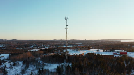 scenic winter aerial flying around a cell site tower at sunset