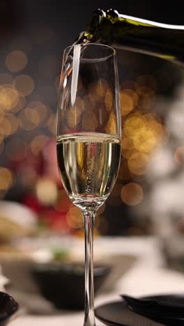 champagne being poured into a flute glass