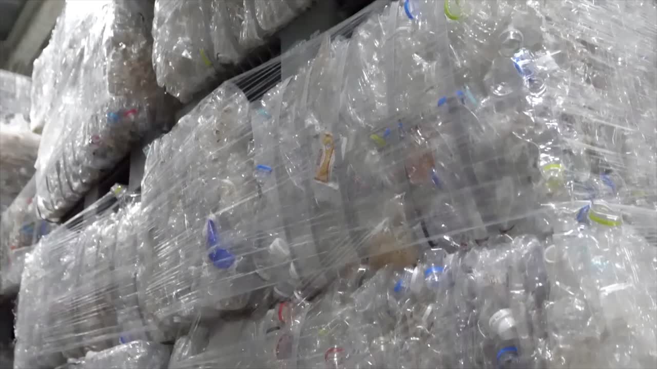 Waste recycling concept. Stack of recycled plastic bags at recycling plant. Piles of compressed plastic bottles prepared for recycling.