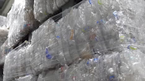 waste recycling concept. stack of recycled plastic bags at recycling plant. piles of compressed plastic bottles prepared for recycling.