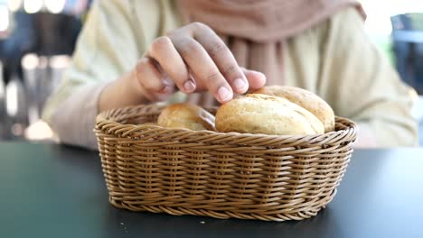 woman eating bread from a basket