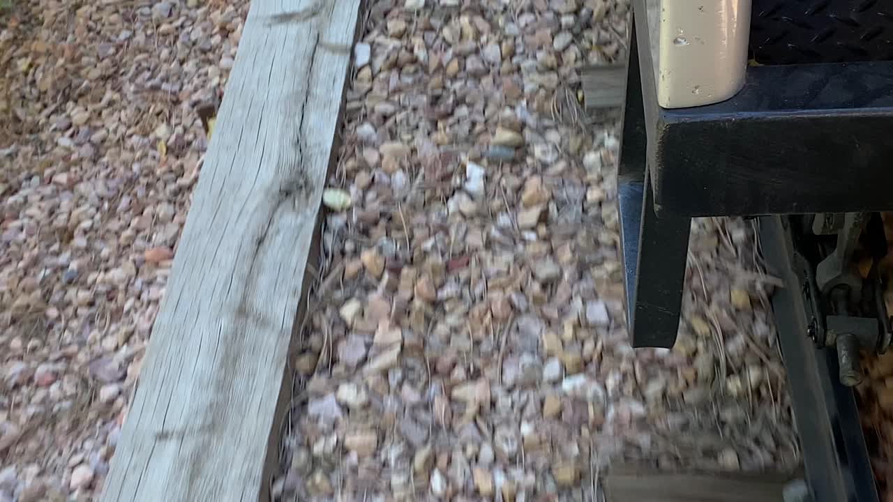 Railway tracks seen from small locomotive, amusement park train attraction